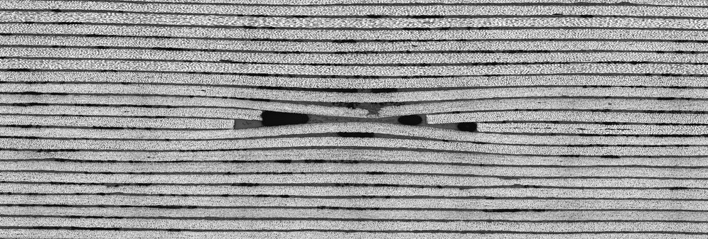 cross section of a layered composite material with break in middle, select to go to Manufacturing and Design research web page